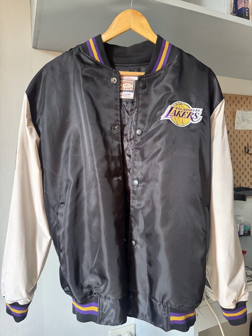 Mitchell & Ness Los Angeles Lakers Hardwood Classics Jacket (Category: Coats, Jackets and Outerwear) located in Manila. Submitted by cvpeb (Listing ID 1442403305, Image 2). Description: - Classic Los Angeles Lakers satin bomber jacket - Features iconic Lakers logo on the chest - Ribbed cuffs and collar with purple and gold stripes - Quilted lining for added warmth - Easy snap button closure - A must-have for any Lakers fan!.