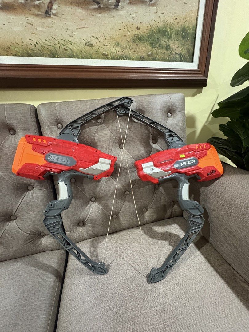 Nerf Mega ThunderBow blasters (Category: Action & Battle Toys) located in Manila. Submitted by dig76 (Listing ID 1442419861, Image 2). Description: 2 pcs available Hasbro Nerf Mega ThunderBow blasters featuring red and orange plastic bodies with grey bow arms..