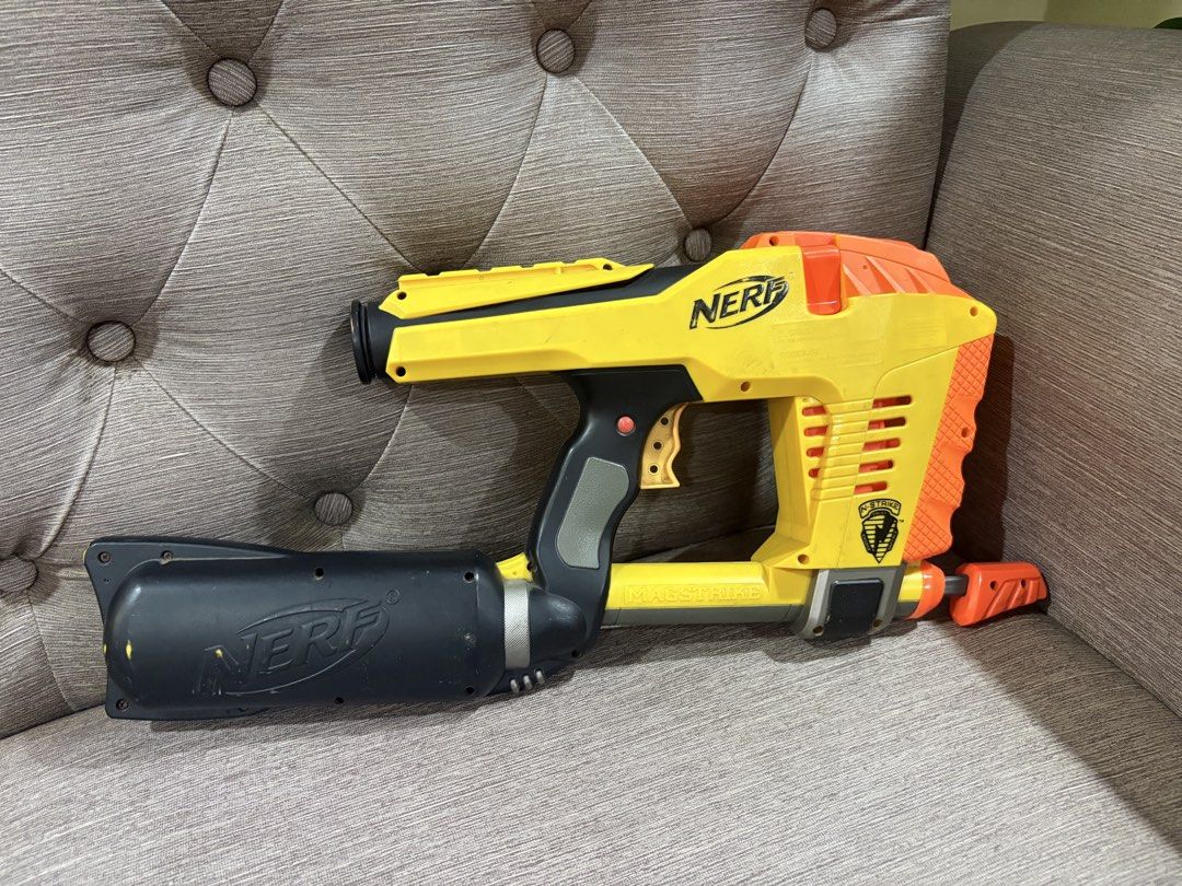 Nerf N-Strike Magstrike CS-6 Blaster Yellow Orange (Category: Action & Battle Toys) located in Manila. Submitted by dig76 (Listing ID 1442424918, Image 1). Description: FAULTY GUN - Yellow and orange Nerf N-Strike Magstrike CS-6 blaster - Includes large black barrel attachment - Shows minor scuffs and marks from play - Fully functional, still fires darts - Perfect for collectors or for playtime.