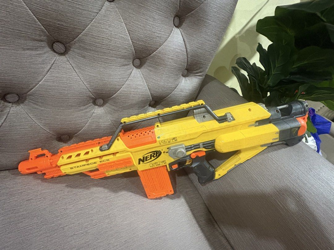 Nerf Stampede ECS Toy Gun (Category: Action & Battle Toys) located in Manila. Submitted by dig76 (Listing ID 1442411001, Image 3). Description: Lightly used Good condition - Yellow and orange Nerf Stampede ECS toy gun - Includes the magazine - Shows scuffs and marks from normal play - Great for kids who love action toys - Ready for fun battles.