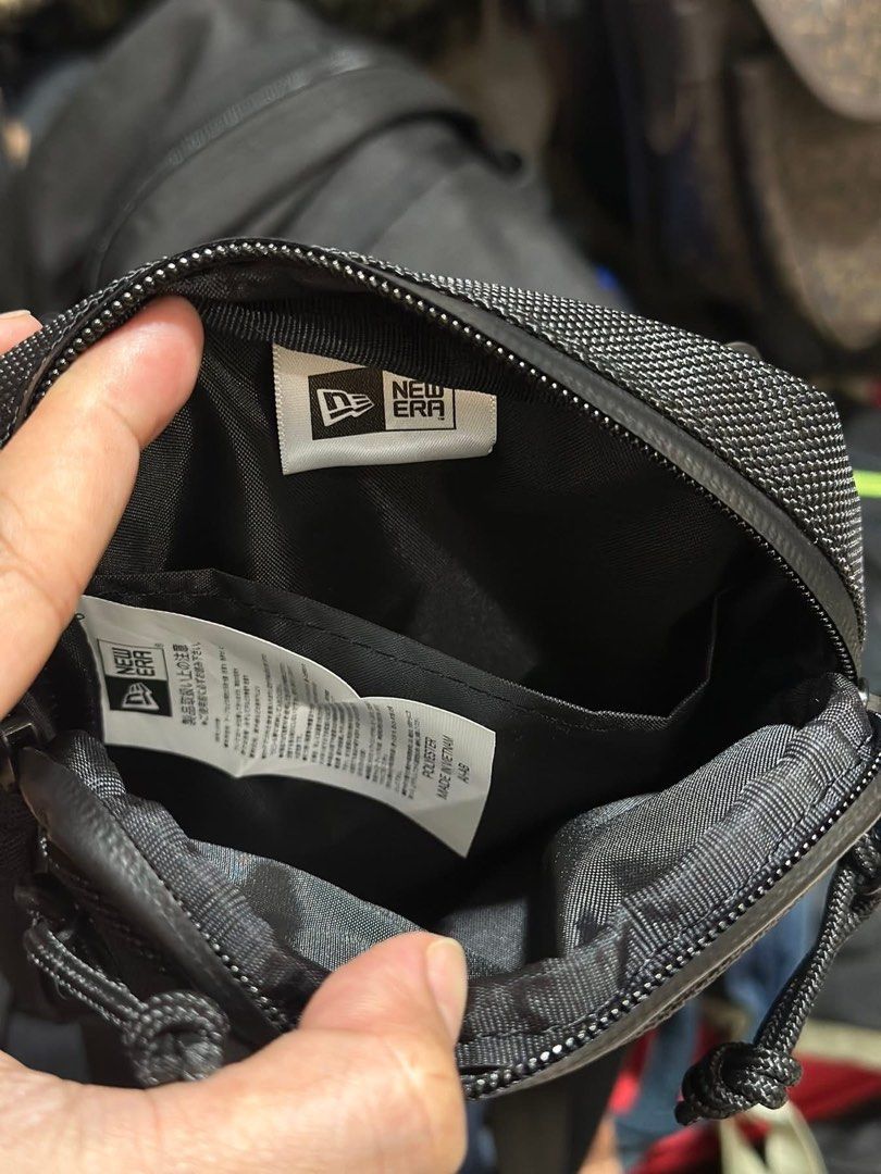 New Era Black Crossbody Bag (Category: Luxury Bags & Wallets) located in Baguio. Submitted by annecicat (Listing ID 1442415626, Image 3). Description: - Brand: New Era - Color: Black - Style: Crossbody Bag - Features: Main zippered compartment, front zippered pocket - Strap: Adjustable - Ideal for: Everyday use, carrying essentials like phone, wallet, and keys.