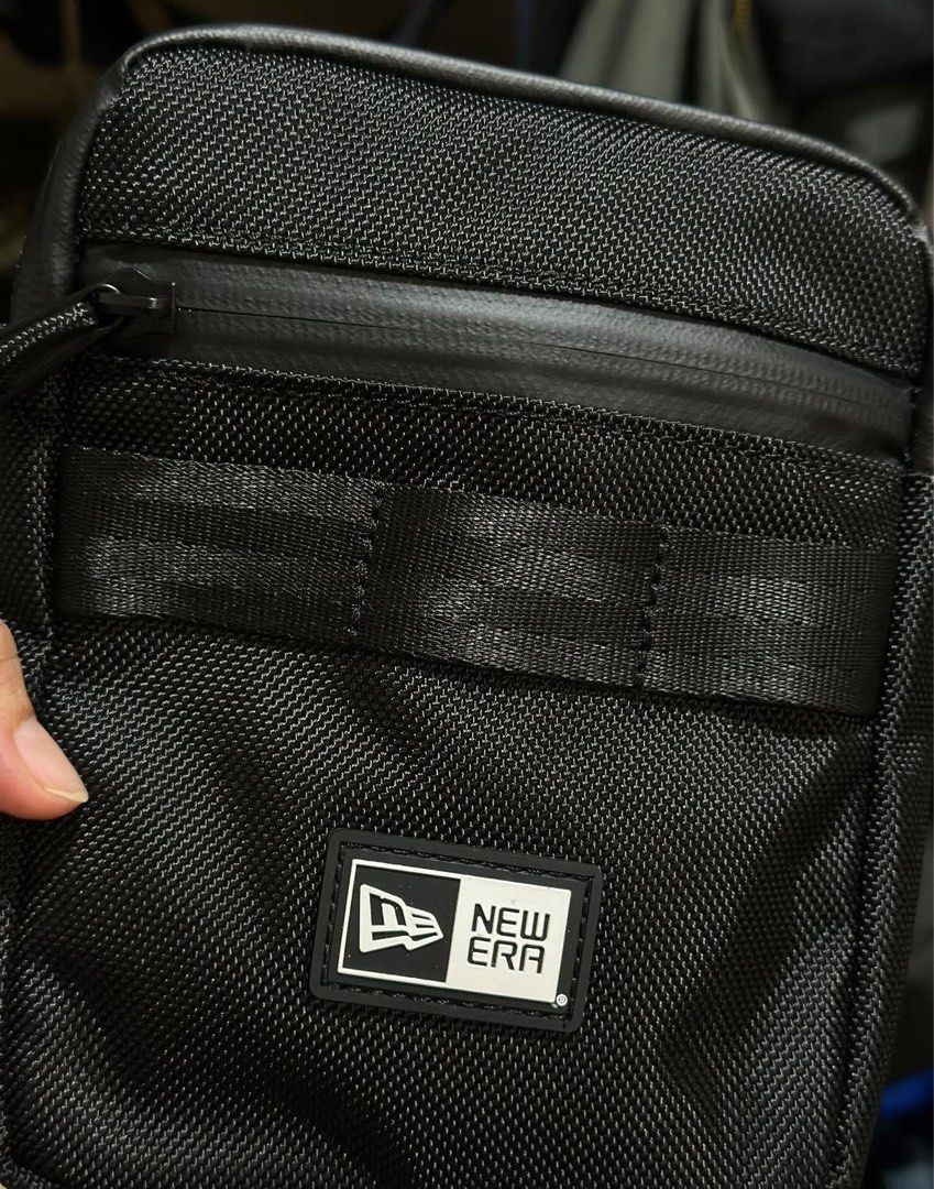 New Era Black Crossbody Bag (Category: Luxury Bags & Wallets) located in Baguio. Submitted by annecicat (Listing ID 1442415626, Image 2). Description: - Brand: New Era - Color: Black - Style: Crossbody Bag - Features: Main zippered compartment, front zippered pocket - Strap: Adjustable - Ideal for: Everyday use, carrying essentials like phone, wallet, and keys.