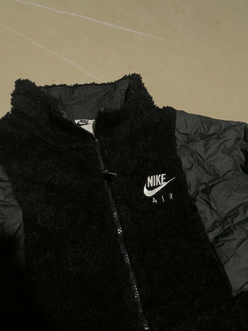Nike Air Fleece and Puffer Jacket (Category: Coats, Jackets and Outerwear) located in Manila. Submitted by yes.jinx (Listing ID 1442471627, Image 2). Description: - Black Nike Air Jacket - Mix of cozy fleece and warm puffer material - Full zip front with convenient kangaroo pocket - Iconic Nike Air logo prominently displayed on the back - Versatile for layering or as a standalone statement piece - Ensures comfort and effortless style.