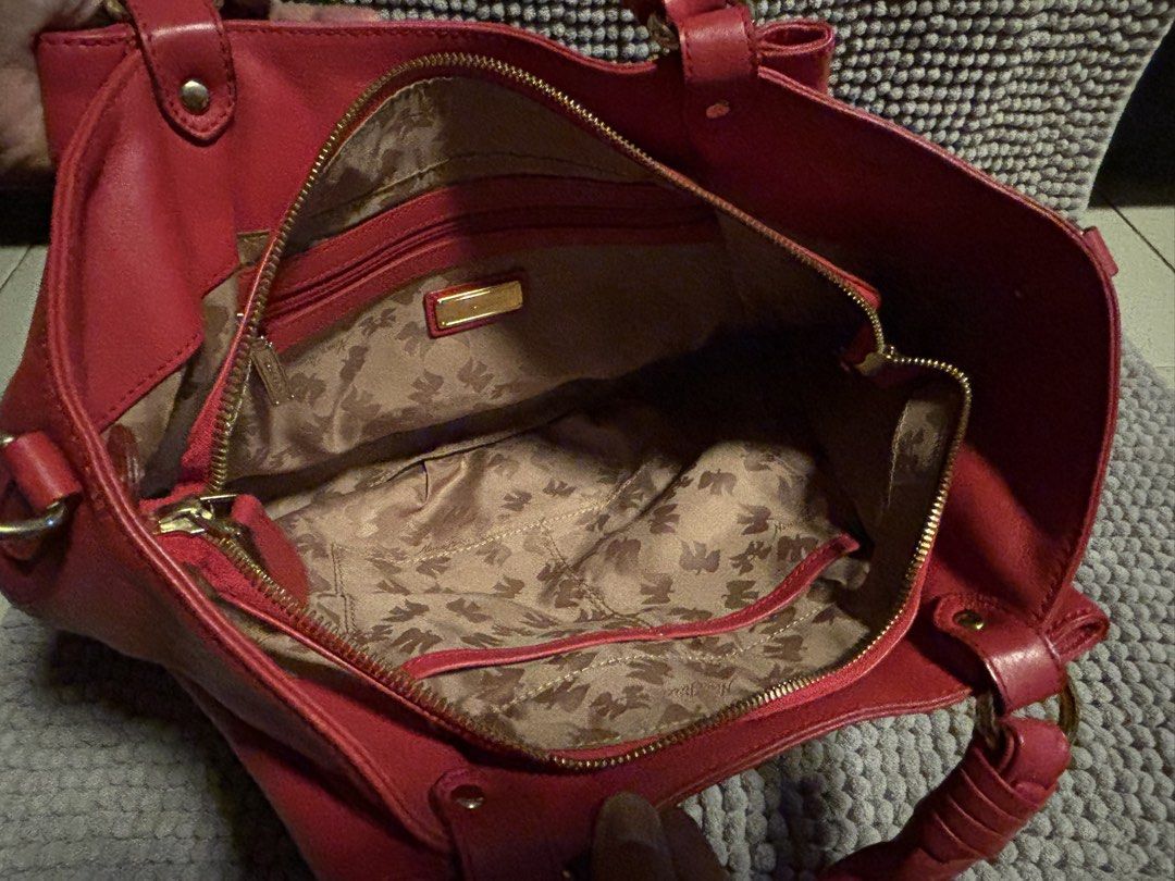 Nina Ricci Red Leather Handbag with Strap (Category: Luxury Bags & Wallets) located in Manila. Submitted by sb92911 (Listing ID 1442380312, Image 3). Description: - Authentic Nina Ricci handbag - Stunning vibrant red color - Genuine leather material - Detachable shoulder strap for versatility Width: ~9 to 11.8 inches (23 to 30 cm) Height: ~7.75 to 8.3 inches (19.7 to 21 cm) Depth: ~4 to 4.7 inches (10 to 12 cm).