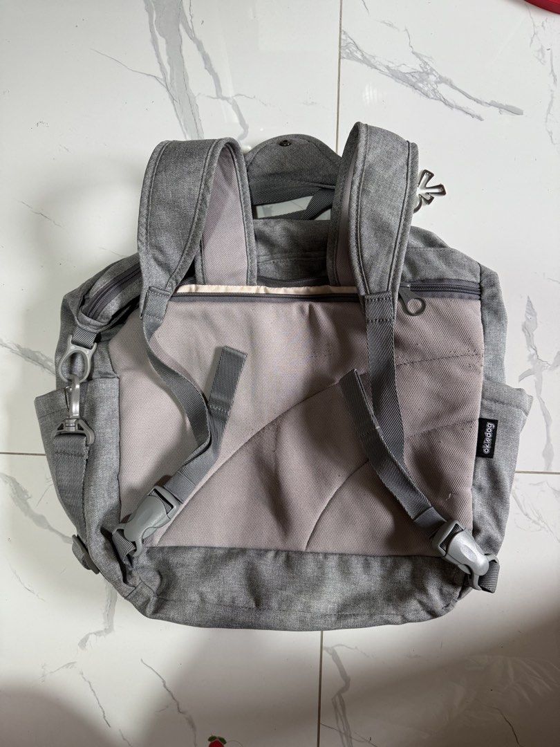 Okiedog Grey Diaper Bag Backpack Tote Convertible (Category: Diaper Bags & Wetbags) located in Quezon City. Submitted by akestrella (Listing ID 1442434584, Image 2). Description: - Grey Okiedog diaper bag - Versatile: can be worn as a backpack or a tote - Numerous pockets inside and out for excellent organization - Comes with a detachable shoulder strap - Sturdy zippers and clasps for durability - Made of heathered grey fabric - Ideal for busy pa
