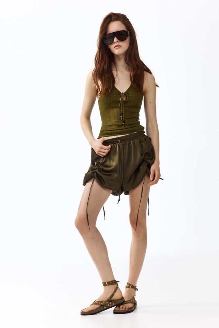 Olive Green Top (Category: Sleeveless) located in Manila. Submitted by paperthread (Listing ID 1442444619, Image 3). Description: - Olive green knit tank top from Divided - Features a tie-front detail with beaded ends - Subtle diamond knit pattern - Sleeveless design with a V-neck - Versatile piece, pairs well with high-waisted bottoms - true to its size.