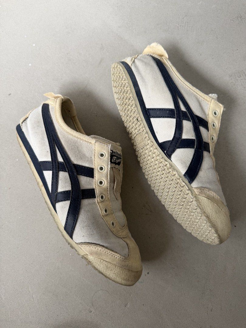 Onitsuka Tiger Mexico 66 Sneakers EURO 37.5 (Category: Sneakers) located in Singapore. Submitted by jsiel (Listing ID 1442403776, Image 3). Description: - Classic Onitsuka Tiger Mexico 66 sneakers - White canvas with navy blue stripes - Slip-on style (no laces required) - Soles show some wear but retain good grip - Ideal for casual wear - Shows some marks and dirt from previous use.