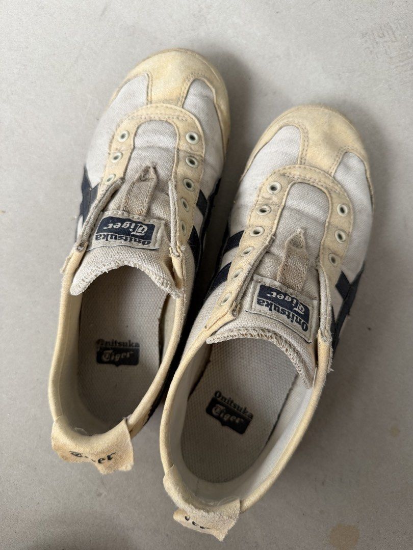 Onitsuka Tiger Mexico 66 Sneakers EURO 37.5 (Category: Sneakers) located in Singapore. Submitted by jsiel (Listing ID 1442403776, Image 1). Description: - Classic Onitsuka Tiger Mexico 66 sneakers - White canvas with navy blue stripes - Slip-on style (no laces required) - Soles show some wear but retain good grip - Ideal for casual wear - Shows some marks and dirt from previous use.