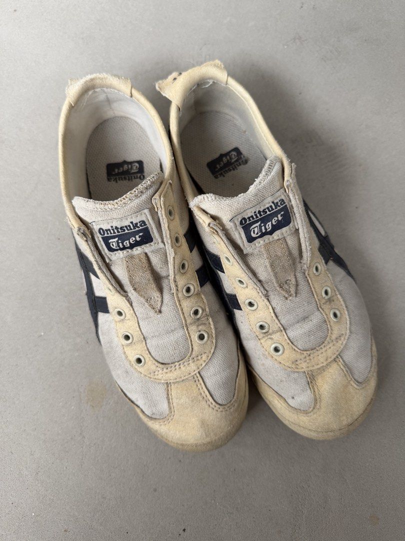 Onitsuka Tiger Mexico 66 Sneakers EURO 37.5 (Category: Sneakers) located in Singapore. Submitted by jsiel (Listing ID 1442403776, Image 2). Description: - Classic Onitsuka Tiger Mexico 66 sneakers - White canvas with navy blue stripes - Slip-on style (no laces required) - Soles show some wear but retain good grip - Ideal for casual wear - Shows some marks and dirt from previous use.
