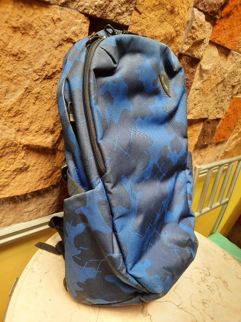 Pacsafe Camo Backpack (Category: Backpacks) located in Bulacan. Submitted by nice.finds (Listing ID 1442387496, Image 3). Description: - Cool blue and black camouflage design - Padded straps for comfort - Breathable mesh back panel - Main compartment with internal organization pockets - Convenient front zip pocket for quick access - Ideal for daily commutes or your next adventure.