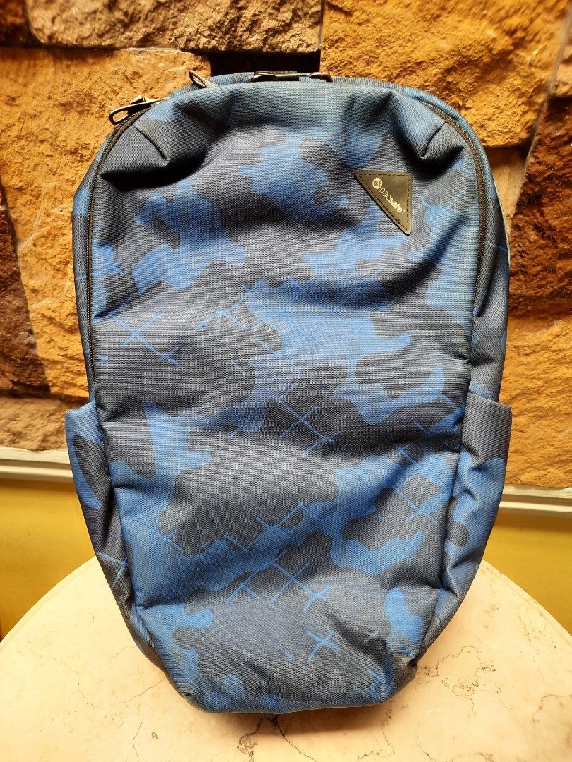 Pacsafe Camo Backpack (Category: Backpacks) located in Bulacan. Submitted by nice.finds (Listing ID 1442387496, Image 1). Description: - Cool blue and black camouflage design - Padded straps for comfort - Breathable mesh back panel - Main compartment with internal organization pockets - Convenient front zip pocket for quick access - Ideal for daily commutes or your next adventure.