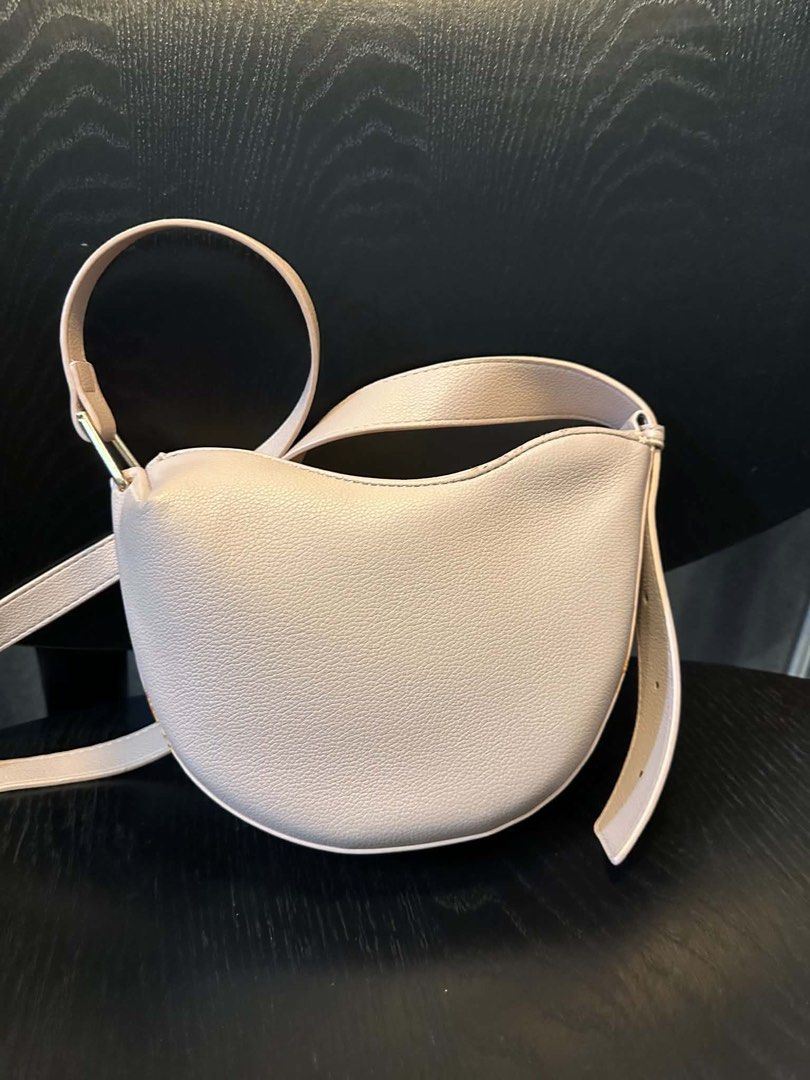 Polene Bag - White Leather Shoulder Bag (Category: Luxury Bags & Wallets) located in Las Pinas. Submitted by gabbiesobremonte20 (Listing ID 1442529223, Image 3). Description: - Polene shoulder bag in a lovely white. - Crafted from durable pebbled leather. - Elegant curved shape. - Single comfortable shoulder strap. - Stylish gold hardware detail on strap attachment. - Versatile: ideal for everyday use or dressing up your look..