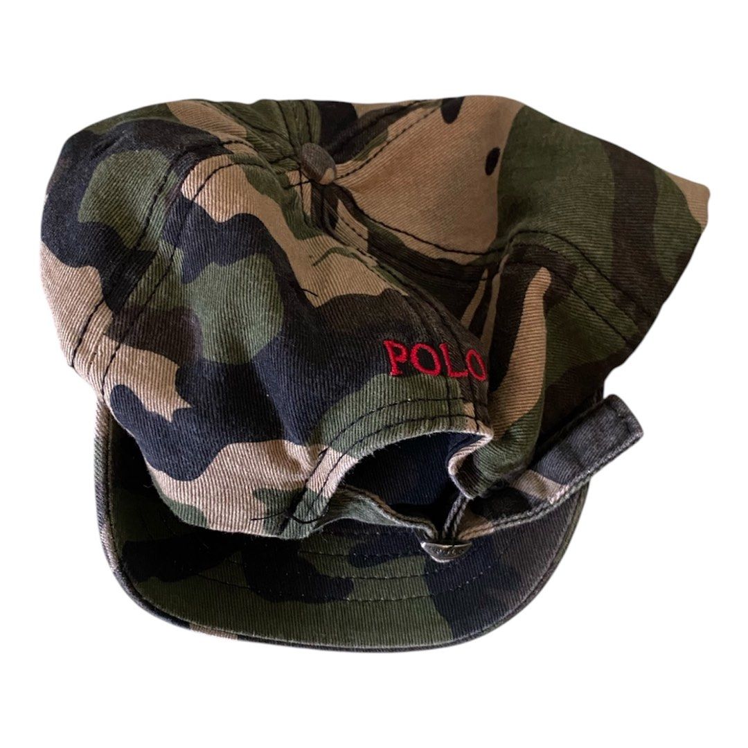 Polo Ralph Lauren Camou (Category: Caps & Hats) located in Tigaon. Submitted by rap2k (Listing ID 1442351559, Image 2). Description: - Classic camouflage baseball cap by Polo Ralph Lauren - Features iconic red Polo player logo embroidery on the front - Adjustable strap at the back for a custom fit - One size fits most - Ideal for casual and everyday wear.