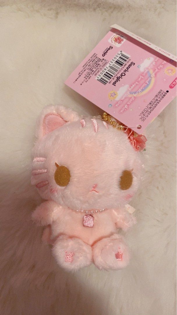 Sanrio Original Pink Cat Plush Keychain (Category: Plushies & Soft Toys) located in Cebu City. Submitted by mysweetmelo08 (Listing ID 1442345737, Image 1). Description: - Authentic Sanrio Original pink cat plush keychain. - Features a delicate pearl necklace and a sparkly charm. - Brand new with tag still attached. - Perfect accessory for bags or keys. - Approximately 4 inches in height..