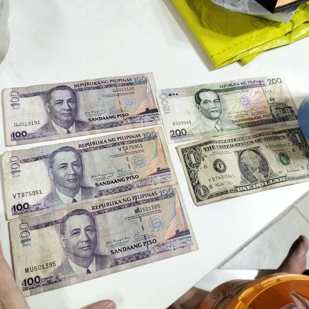 Selling old Philippine paper bills (Category: Currency) located in Paranaque City. Submitted by decluttering-all (Listing ID 1407971919, Image 2). Description: Selling old Philippine paper bills 100 peso bill (2004-2, 2003-1) 3 pcs 200 paper bill (2004) 1 pc $1 us dollar bill series 2001 P600 take all decluttering pick up beside Toyota Bicutan Paranaque payment through BPI or gcash.