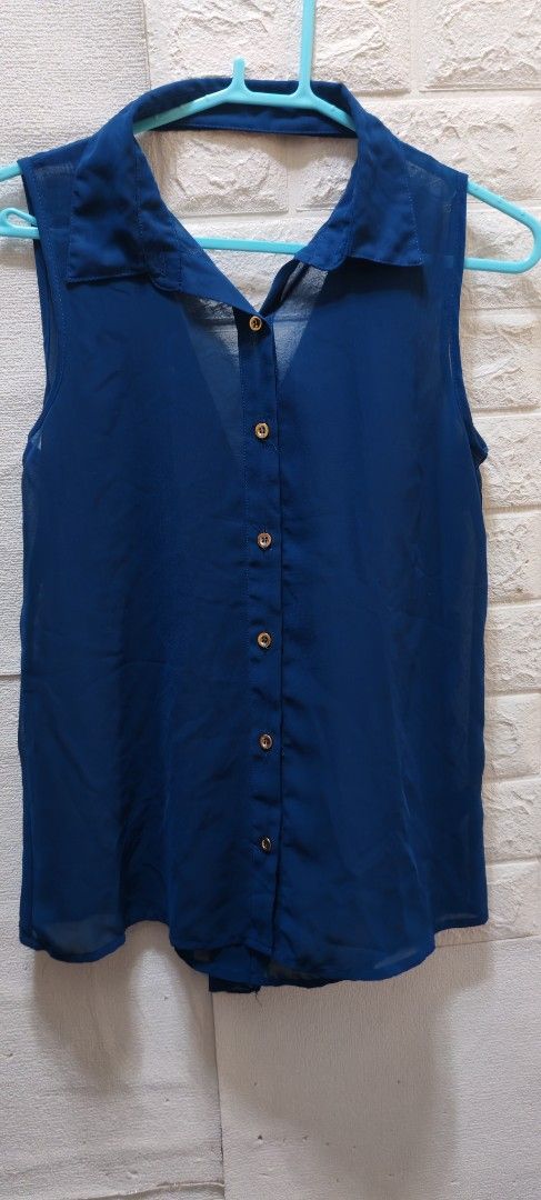 Sheer Sleeveless Collared Button-Up Blouse - Size S (Category: Blouses) located in Rizal. Submitted by annmaria_declutter (Listing ID 1442434434, Image 1). Description: - Navy blue sleeveless blouse - Sheer material - Collared neckline - Button-up front with gold-tone buttons - Lightweight and flowy fabric - Perfect for layering or wearing solo - Size: S - Material: 100% Polyester -seetrough you need inner. Can fit up to M .