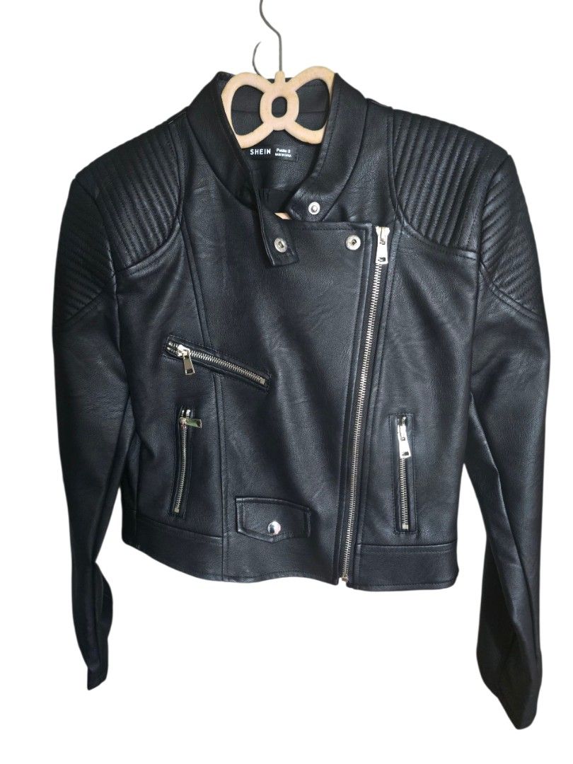 SHEIN Black Faux Leather Biker Jacket (Category: Coats, Jackets and Outerwear) located in Cainta. Submitted by rejean18 (Listing ID 1442443580, Image 1). Description: - Black faux leather biker jacket from SHEIN - Classic asymmetrical zip front - Zippered pockets - Snap button details - Ribbed texture on shoulders - Perfect for an edgy, layered look.