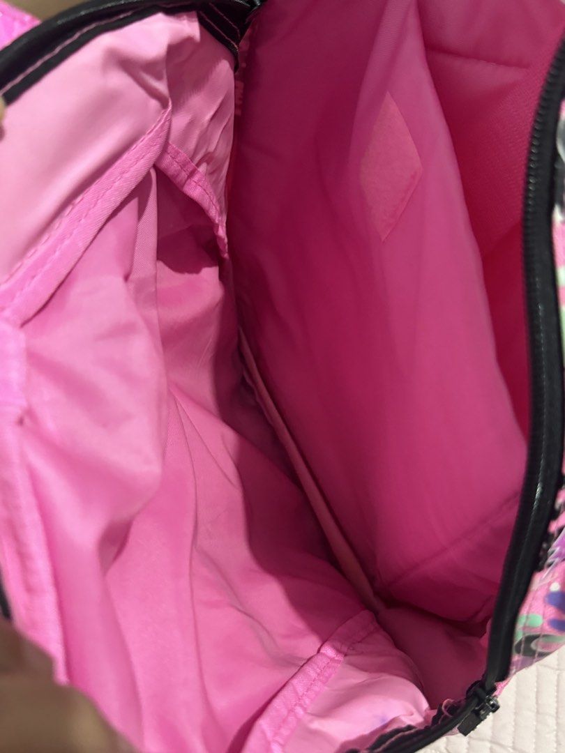 Smiggle Backpack Cat Space Theme Pink Purple (Category: Babies & Kids Fashion) located in Manila. Submitted by mitchvi88823135 (Listing ID 1442359161, Image 3). Description: - Adorable Smiggle backpack with a fun cat in space design. - Features stars and planets in vibrant pink and purple colors. - Includes a spacious main compartment and a convenient front zip pocket. - Padded shoulder straps ensure comfortable wear. - Ideal for school, daycare,