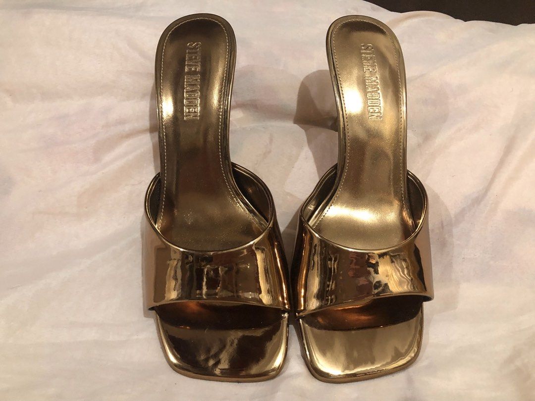Steve Madden Bronze Metallic Square Toe Heeled Mules (Category: Heels) located in Quezon City. Submitted by polluxfineshop (Listing ID 1442433128, Image 1). Description: - Brand: Steve Madden - Color: Gold Metallic - Style: Heeled Mules - Toe Shape: Square Toe - Closure: Slip-on - Features: Statement piece, easy to wear, moderate heel height - Size 7.5 US .
