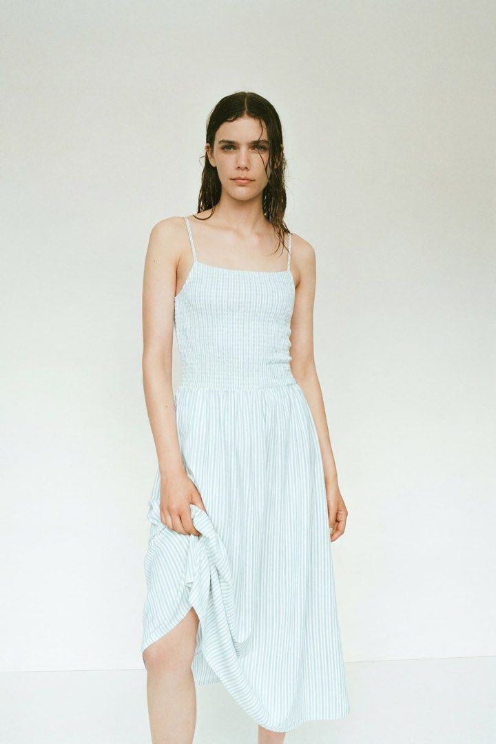 Strappy dress (Category: Dresses) located in Manila. Submitted by paperthread (Listing ID 1442445227, Image 2). Description: - Light blue and white striped midi dress - Smocked bodice - Spaghetti straps - Flowy, mid-calf length skirt - Ideal for casual outings or beach days - Comfortable and easy to wear.