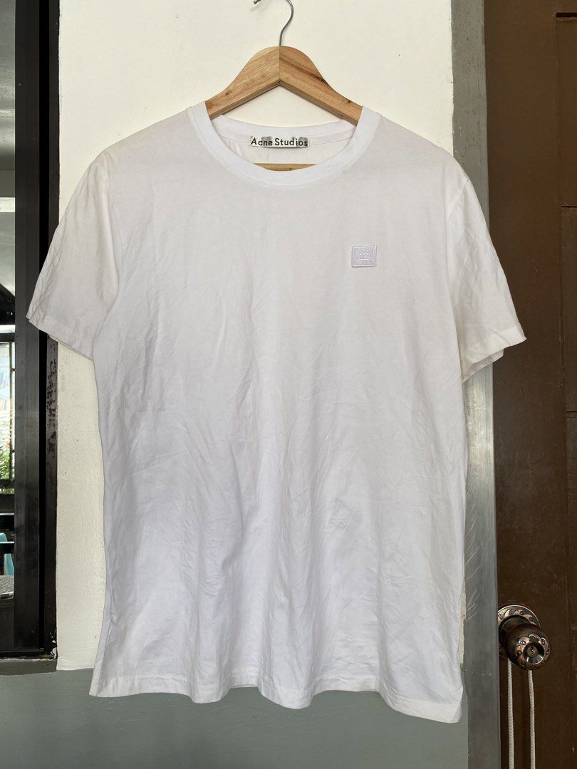 This white Acne Studios T-shirt features the signature tonal embroidered face logo patch on the chest (Category: Tshirts & Polo Shirts ) located in Manila. Submitted by luxbyjyy (Listing ID 1442484847, Image 1). Description: This white Acne Studios T-shirt features the signature tonal embroidered face logo patch on the chest Dimension:W20 L27.