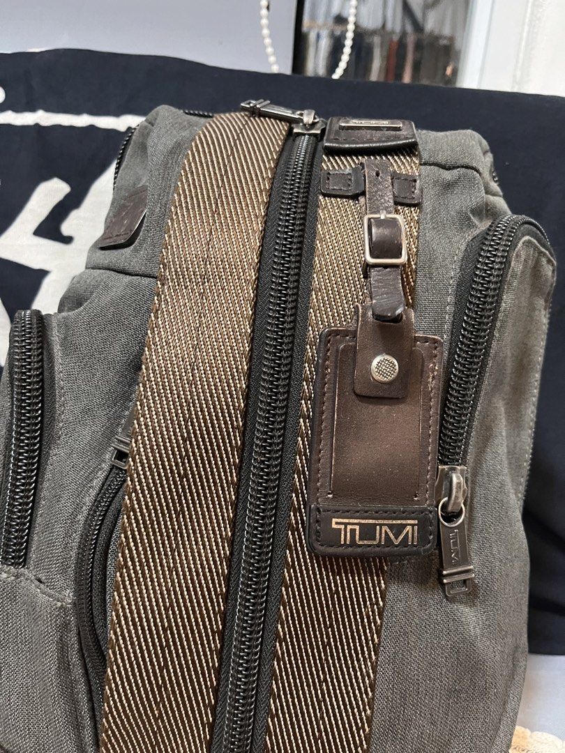 Tumi Sling Bag Grey Canvas Leather Trim (Category: Belt bags, Clutches and Pouches) located in Davao. Submitted by 4mscllection (Listing ID 1442404508, Image 2). Description: - Grey Tumi sling bag - Durable canvas and leather details - Multiple zippered compartments for organization - Adjustable strap for comfortable wear - Perfect for everyday use.