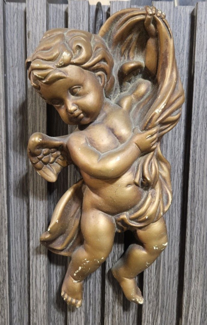 Vintage Gold Cherub Angel Wall Hanging Decor (Category: Wall Decor) located in Rizal. Submitted by cherry_garcia (Listing ID 1442421621, Image 1). Description: - Adorable cherub angel wall hanging - Elegant gold-tone finish - Stands approximately 9 inches tall - Features minor paint chips, consistent with vintage charm - Adds a touch of vintage charm to any space - Ideal for nurseries, living rooms, or any room needing a sweet accent.
