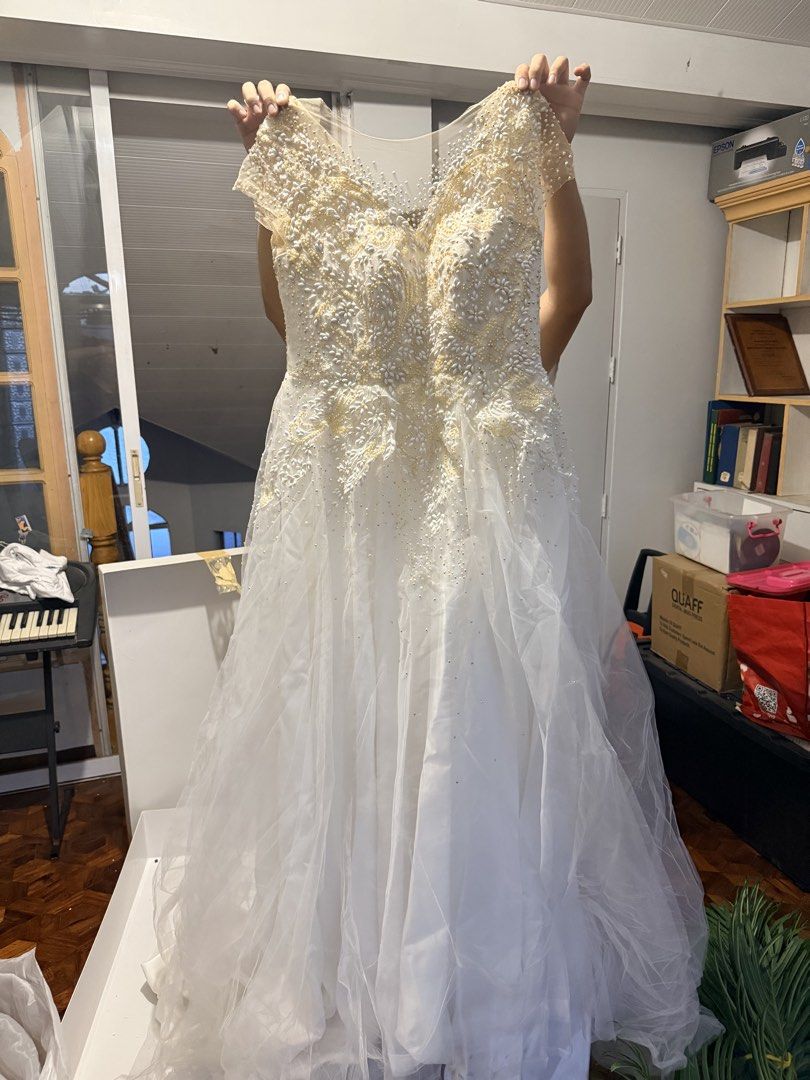 Wedding Gown with petticoat (Category: Evening dresses & gowns) located in Pasig City. Submitted by icyansp (Listing ID 1442457135, Image 2). Description: I’m selling my wedding gown as-is. The gown features detailed, heavy beadwork and embroidery all across the bodice. 📌 PLEASE READ DETAILS BEFORE PMing: • Condition: Pre-loved, As-Is. The intricate beadwork and structure are intact. However, due to storage, there is visible yellowing concentrat
