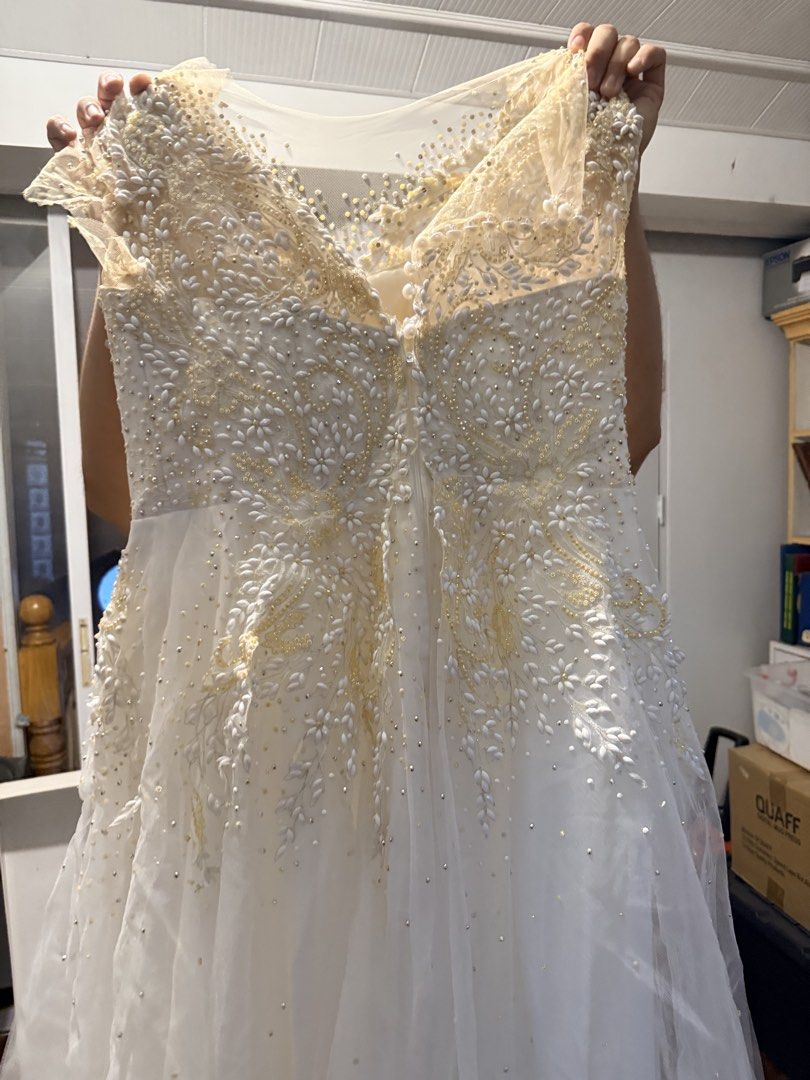 Wedding Gown with petticoat (Category: Evening dresses & gowns) located in Pasig City. Submitted by icyansp (Listing ID 1442457135, Image 3). Description: I’m selling my wedding gown as-is. The gown features detailed, heavy beadwork and embroidery all across the bodice. 📌 PLEASE READ DETAILS BEFORE PMing: • Condition: Pre-loved, As-Is. The intricate beadwork and structure are intact. However, due to storage, there is visible yellowing concentrat