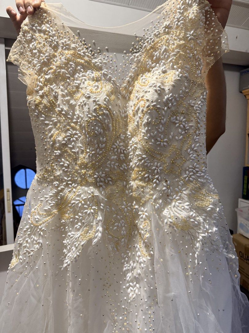 Wedding Gown with petticoat (Category: Evening dresses & gowns) located in Pasig City. Submitted by icyansp (Listing ID 1442457135, Image 1). Description: I’m selling my wedding gown as-is. The gown features detailed, heavy beadwork and embroidery all across the bodice. 📌 PLEASE READ DETAILS BEFORE PMing: • Condition: Pre-loved, As-Is. The intricate beadwork and structure are intact. However, due to storage, there is visible yellowing concentrat