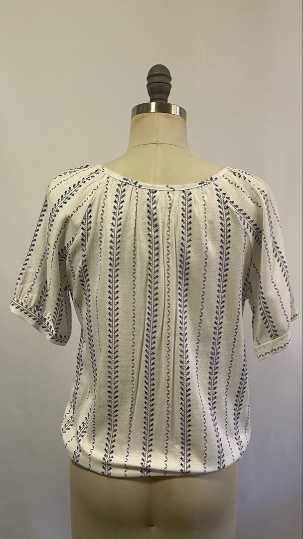 White and Navy Striped Tie-Neck Blouse (Category: Blouses) located in General Trias. Submitted by 1992thelabel (Listing ID 1442466643, Image 3). Description: - Casual white blouse with navy vertical stripes - Features a tie-neck detail at the scoop neckline - Short, gathered sleeves - Lightweight fabric, ideal for warm weather - Versatile: pairs easily with jeans or shorts.
