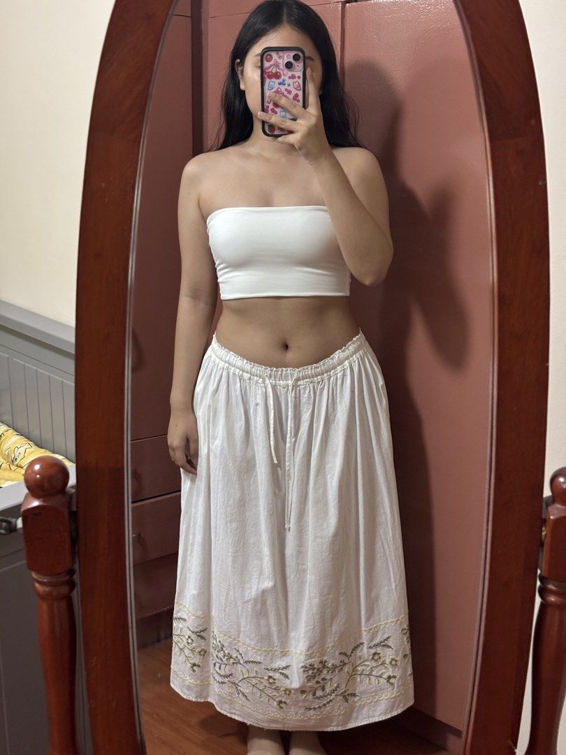 White Maxi Skirt with Embroidered Hem (Category: Skirts) located in Bocaue. Submitted by parsimonybysf (Listing ID 1442527090, Image 1). Description: - Freesize - Has pockets - Flowy white maxi skirt - Adjustable drawstring waist - Delicate green and yellow floral embroidery on hem - Ideal for casual wear or beach vibes - Comfortable and breathable fabric.