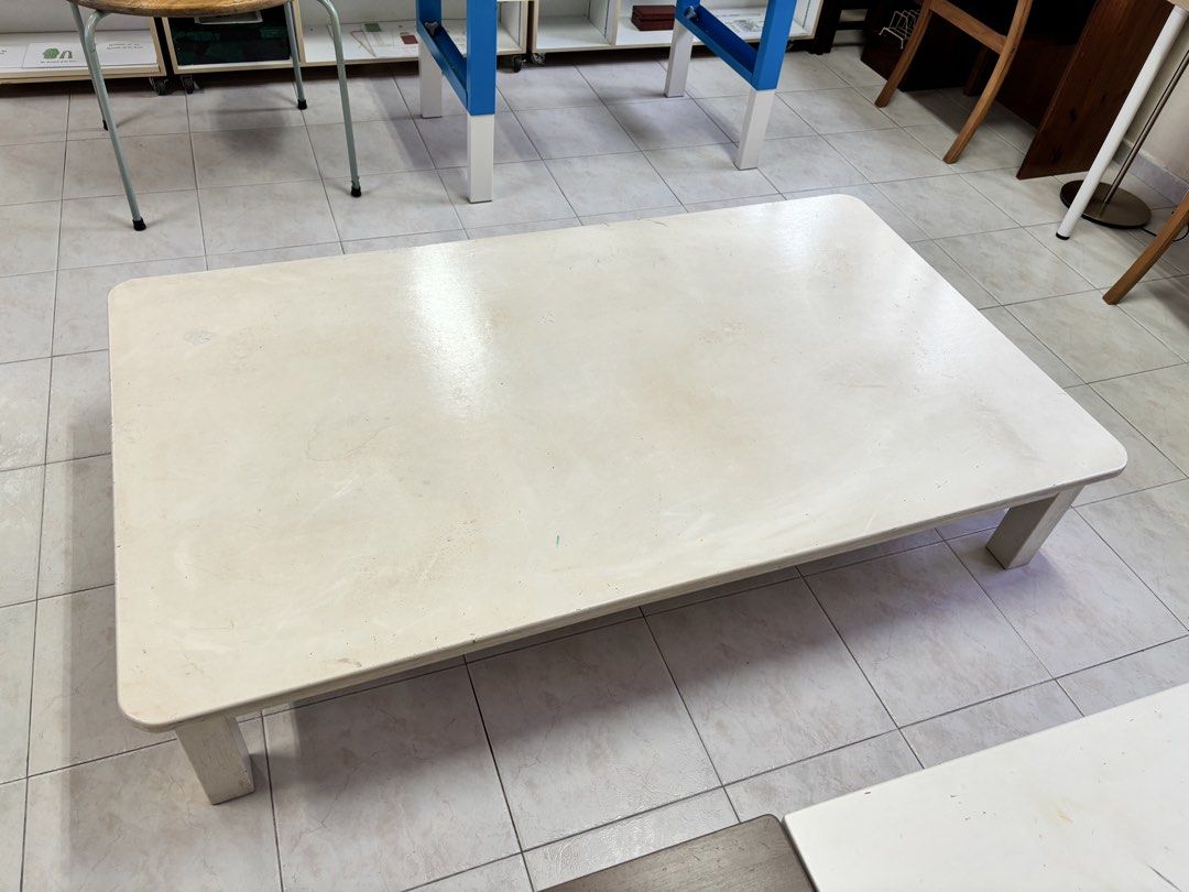 White Rectangular Coffee Table / Children’s Table / Floor Table (Category: Tables & Sets) located in Singapore. Submitted by rtan77 (Listing ID 1442414708, Image 2). Description: - White rectangular coffee table - Low profile design - Shows some scuffs and marks on the surface (from use) - Sturdy legs - Suitable for living room or study area - Approx. dimensions: 168cm length x 97cm width x 33cm height.