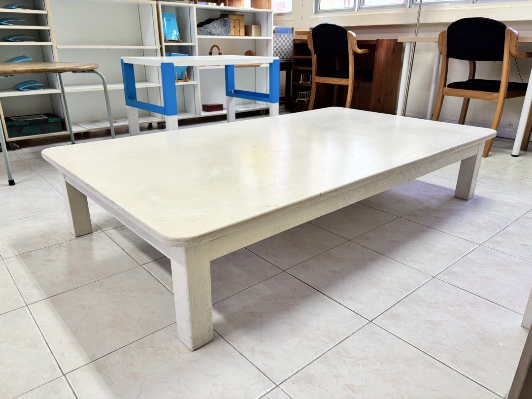 White Rectangular Coffee Table / Children’s Table / Floor Table (Category: Tables & Sets) located in Singapore. Submitted by rtan77 (Listing ID 1442414708, Image 1). Description: - White rectangular coffee table - Low profile design - Shows some scuffs and marks on the surface (from use) - Sturdy legs - Suitable for living room or study area - Approx. dimensions: 168cm length x 97cm width x 33cm height.