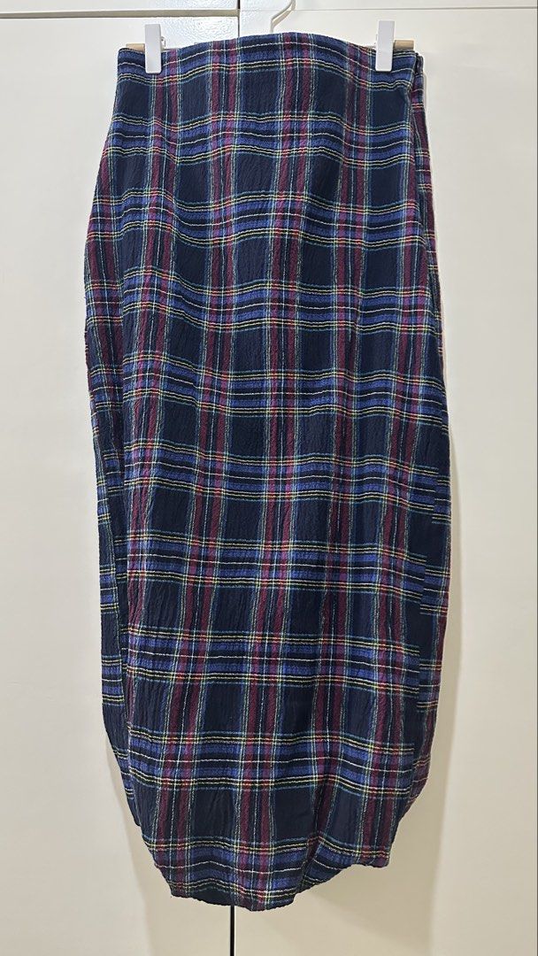 Zara Plaid Midi Skirt Size M (Category: Skirts) located in Bacolod City. Submitted by pym_shops (Listing ID 1442456055, Image 2). Description: - Zara midi skirt - Classic plaid pattern with navy, red, blue, and yellow checks - Slightly crinkled fabric texture - Estimated size: Medium - Versatile for casual and smart-casual outfits.