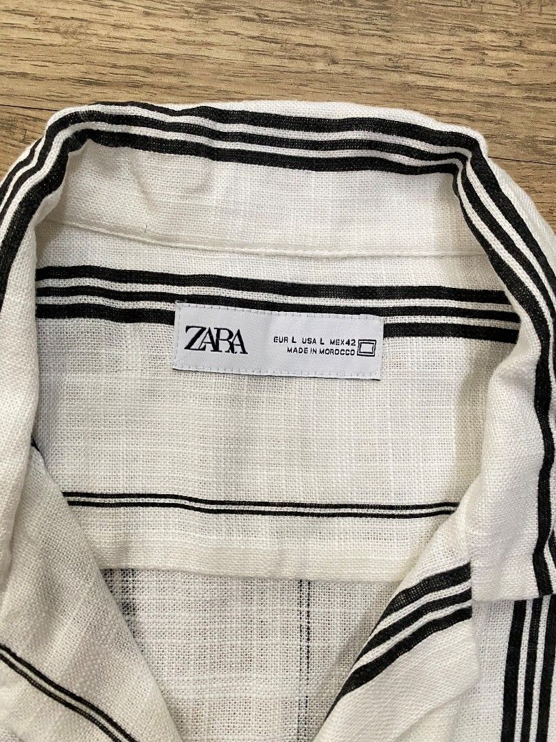 ZARA Striped Short Sleeve Shirt (Category: Tshirts & Polo Shirts ) located in Manila. Submitted by francloset_1 (Listing ID 1442489028, Image 3). Description: - White short-sleeve button-up shirt - Features black vertical stripes - Made from a comfortable linen-blend fabric - Ideal for casual outings or beach vacations - Breathable material - Tagged size M 23/28.5 no issue.