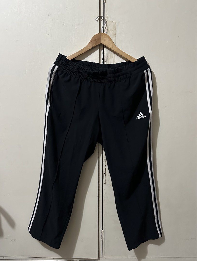 Adidas Black Track Pants with White Stripes (Category: Activewear) located in Manila. Submitted by 4buying (Listing ID 1442640722, Image 1). Description: - Black Adidas track pants - Classic white stripes down the sides - Comfortable elastic waistband - Adidas logo on the left leg - Made in Indonesia - Size: L (fits like Asia XL) - Ideal for sports and casual wear.