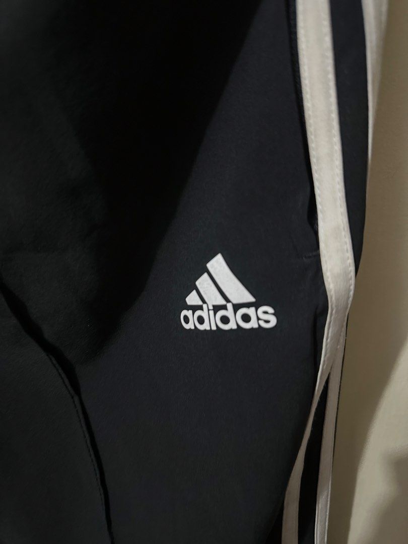 Adidas Black Track Pants with White Stripes (Category: Activewear) located in Manila. Submitted by 4buying (Listing ID 1442640722, Image 2). Description: - Black Adidas track pants - Classic white stripes down the sides - Comfortable elastic waistband - Adidas logo on the left leg - Made in Indonesia - Size: L (fits like Asia XL) - Ideal for sports and casual wear.