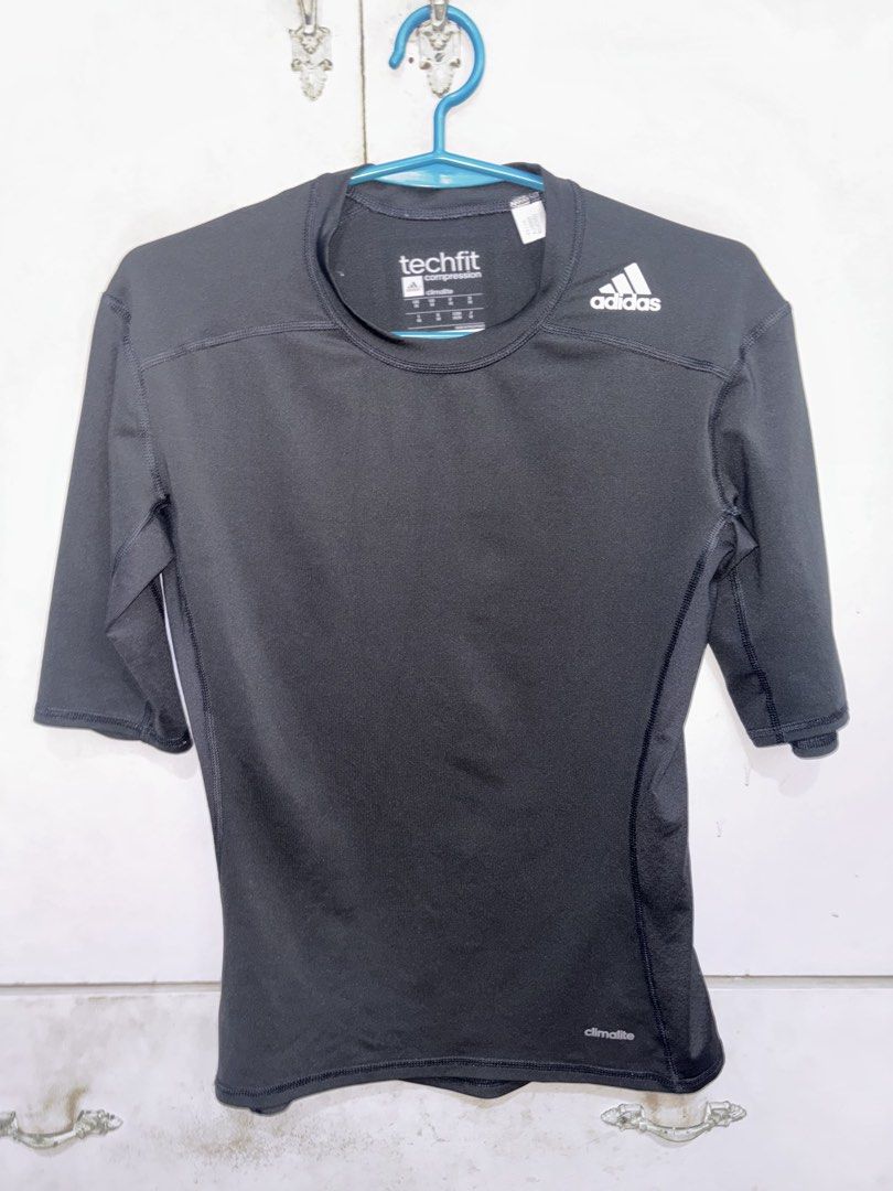 Adidas Techfit Compression 3/4 Sleeve Top Climalite Black (Category: Activewear) located in Pasig City. Submitted by timmybatoon (Listing ID 1442640946, Image 1). Description: - Black Adidas Techfit compression top - 3/4 sleeves - Climalite fabric for sweat-wicking - Ideal for workouts or as a base layer - Comfortable and supportive fit - Features Adidas logo and Techfit branding.
