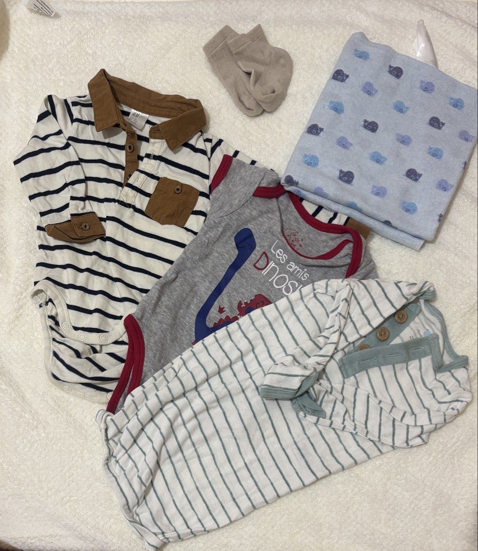 Baby Boy Clothes Bundle - Bodysuits, Sleepsuit, Socks, Blanket (Category: Babies & Kids Fashion) located in Binan City. Submitted by mjmsc (Listing ID 1442636508, Image 1). Description: - Bundle includes 3 essential baby boy clothing items. - Features a striped long-sleeve bodysuit with collar and pocket. - Includes a grey bodysuit with a cute dinosaur print. - Comes with a white and green striped sleepsuit with button details. - Also includes a 