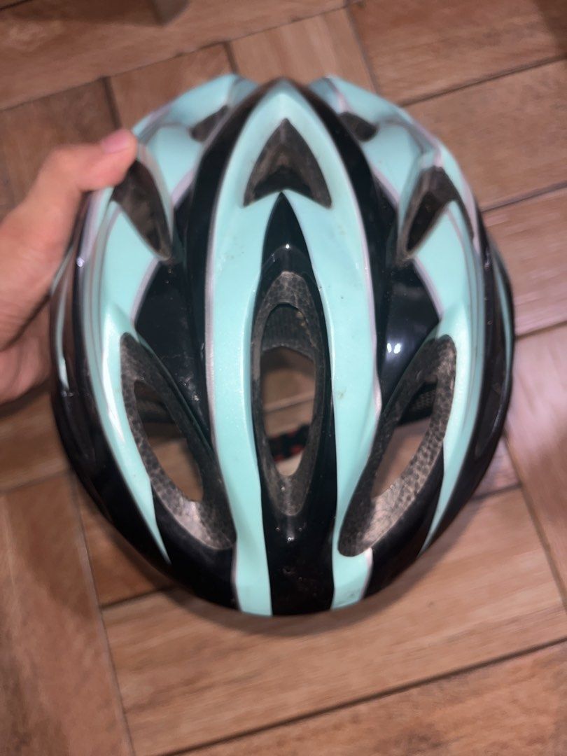 Black and Teal Cycling Helmet (Category: Other Sports Equipment and Supplies) located in Makati City. Submitted by gabrayco (Listing ID 1442625418, Image 2). Description: - Black cycling helmet with stylish teal accents - Designed for excellent airflow with multiple vents - Features adjustable straps and an internal fit system for a secure feel - Pre-loved with some signs of wear, inside and out - Perfect for your next cycling adventure!.