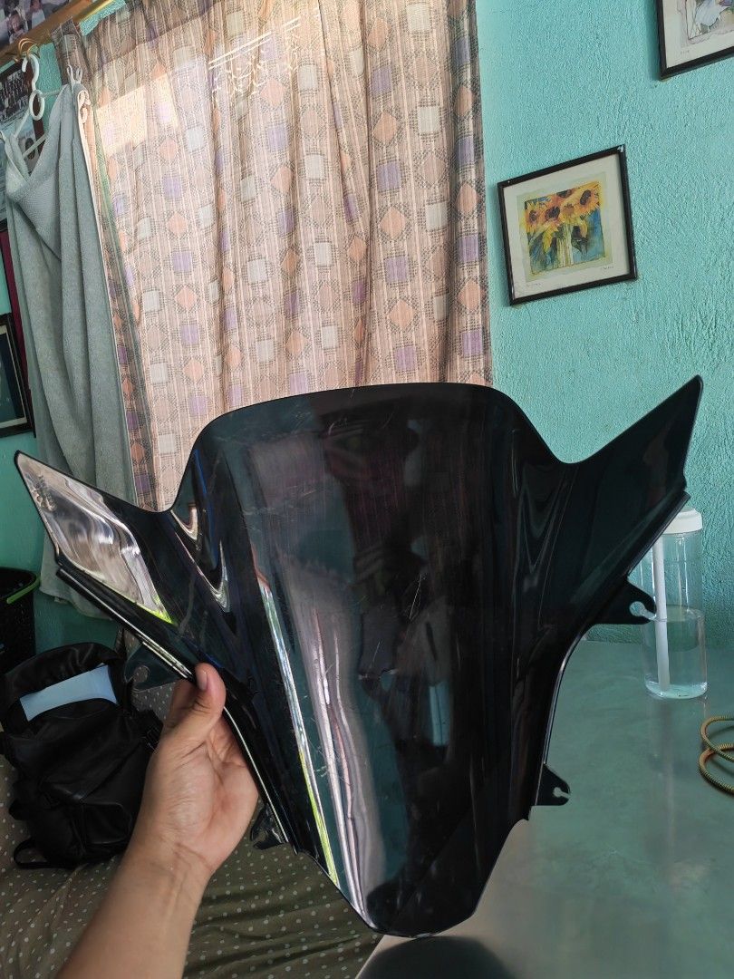 Black Motorcycle Windshield Fairing (Category: Helmets and other Riding Gears) located in Carmona. Submitted by tech_hub_cavite (Listing ID 1442623554, Image 3). Description: - Black motorcycle windshield - Dark, tinted material - Side mounting points for easy installation - Shows light scratches from previous use.