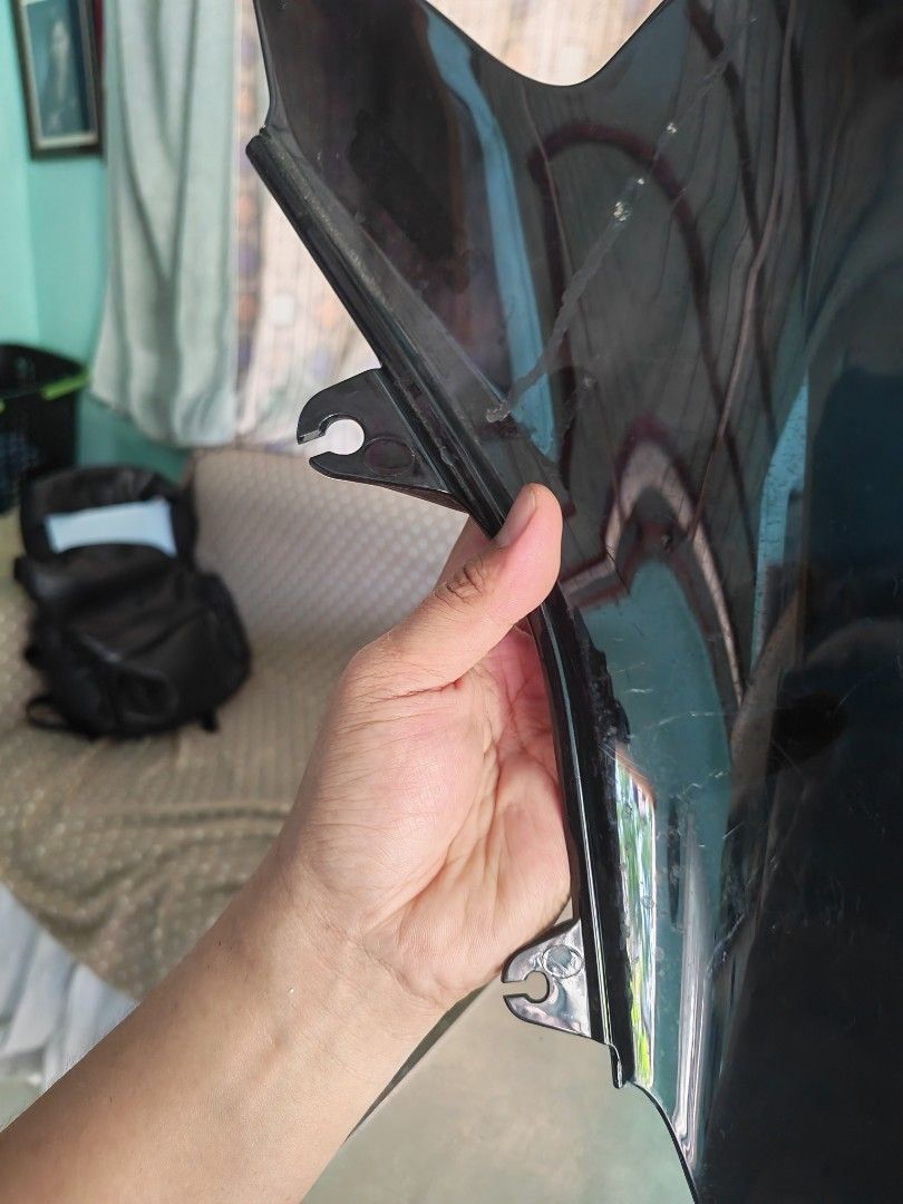 Black Motorcycle Windshield Fairing (Category: Helmets and other Riding Gears) located in Carmona. Submitted by tech_hub_cavite (Listing ID 1442623554, Image 2). Description: - Black motorcycle windshield - Dark, tinted material - Side mounting points for easy installation - Shows light scratches from previous use.