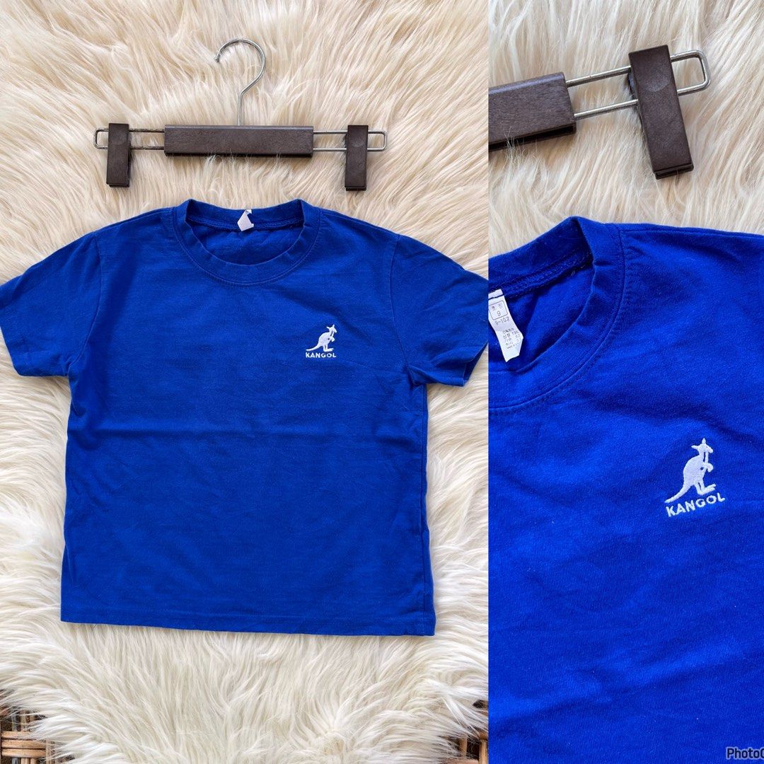 Blue Kangol T-shirt with Kangaroo Logo (Category: Babies & Kids Fashion) located in Valencia. Submitted by kathrift (Listing ID 1442668766, Image 1). Description: - Classic blue Kangol t-shirt - Features iconic embroidered kangaroo logo on chest - Simple crew neck and short sleeves - Perfect for casual wear.