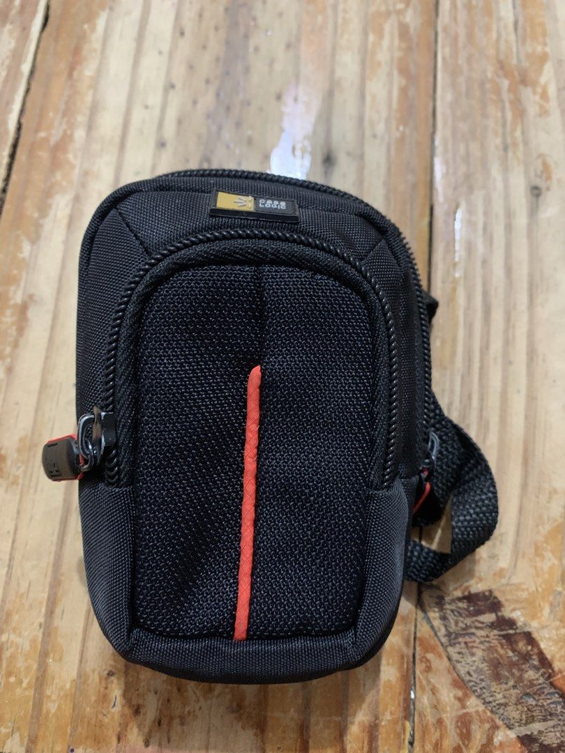 CASE LOGIC Black Camera/Phone Pouch Bag with Strap (Category: Camera Bags & Carriers) located in Bacoor. Submitted by its_cess (Listing ID 1442719301, Image 1). Description: - Small black pouch for compact cameras - Belt loop and carabiner clip for easy carrying - Secure zipper closure - Stylish orange accent stitching - Ideal for protecting your digital camera while traveling.