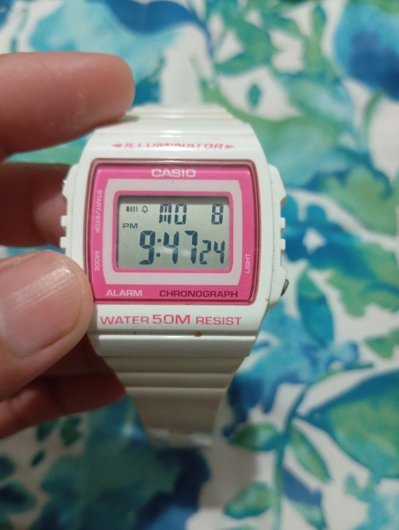 Casio Digital Watch W-215H White Pink (Category: Women's Watches) located in Muntinlupa City. Submitted by thriftsmuntinlupa26 (Listing ID 1442680465, Image 2). Description: - White Casio digital watch - Pink bezel - Alarm function - Chronograph function - Water resistant up to 50 meters - Strap has signs of wear - Battery is working - Ideal for everyday use.