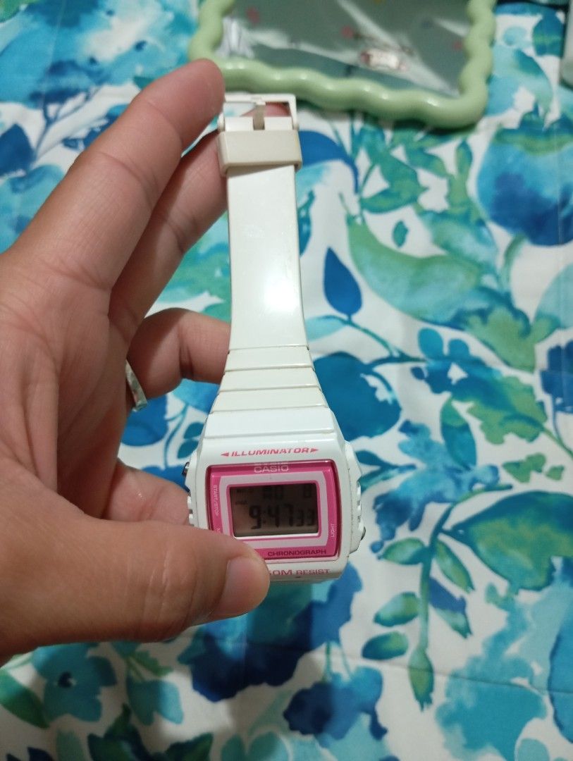 Casio Digital Watch W-215H White Pink (Category: Women's Watches) located in Muntinlupa City. Submitted by thriftsmuntinlupa26 (Listing ID 1442680465, Image 3). Description: - White Casio digital watch - Pink bezel - Alarm function - Chronograph function - Water resistant up to 50 meters - Strap has signs of wear - Battery is working - Ideal for everyday use.