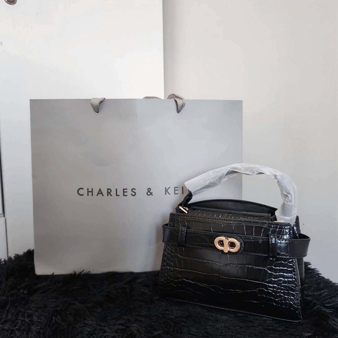 Charles & Keith Mini Top Handle Bag (Category: Luxury Bags & Wallets) located in Manila. Submitted by rcwluxx (Listing ID 1435674527, Image 2). Description: - Charles & Keith mini top handle bag - Crocodile-embossed finish - Available colors: Black, Burgundy, Cream, Pink - Secure clasp closure - Structured design - Compact size - Top handle - Small inner compartment - Perfect for essentials.