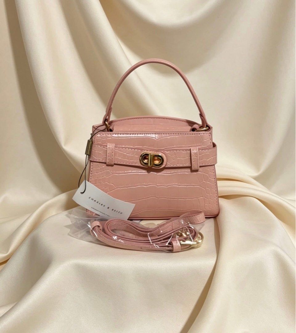 Charles & Keith Mini Top Handle Bag (Category: Luxury Bags & Wallets) located in Manila. Submitted by rcwluxx (Listing ID 1435674527, Image 3). Description: - Charles & Keith mini top handle bag - Crocodile-embossed finish - Available colors: Black, Burgundy, Cream, Pink - Secure clasp closure - Structured design - Compact size - Top handle - Small inner compartment - Perfect for essentials.