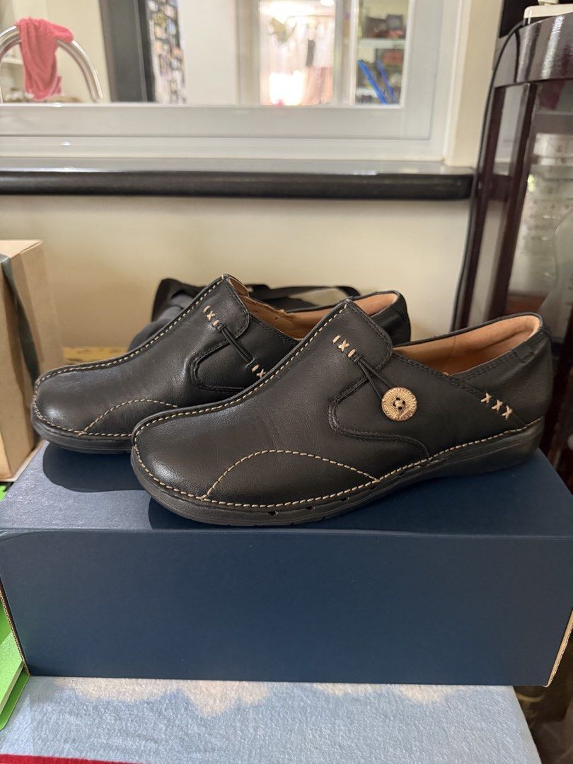 Clarks Black Leather Slip-On Shoes (Category: Loafers) located in Quezon City. Submitted by msafer (Listing ID 1442586807, Image 3). Description: - Brand: Clarks -Size: Women US 9.5 / Men US 8 - Color: Black - Style: Slip-on shoes - Material: Leather - Features: Decorative stitching, button detail on side - Comfort: Comfortable and easy to wear - Sole: Good grip - Ideal for: Everyday use.